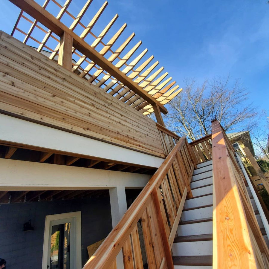 Stairway up to the balcony. Full cedar railing and privacy wall. Composite decking boards.