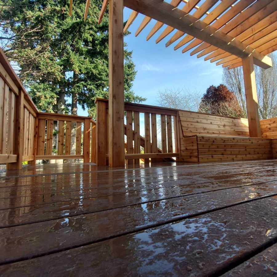 Composite decking by Trex. Cedar railing and matching cedar benches creating privacy wall. Cedar pergola providing shade.