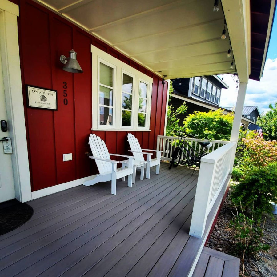 Porch deck red and white wall trex railing.