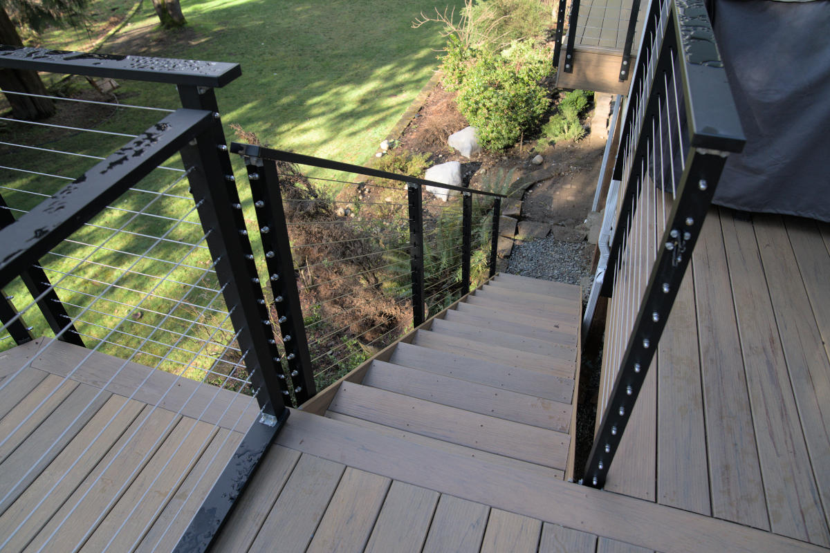 Deck with covered space, cable railing, and fencing in Maple Valley, WA ...