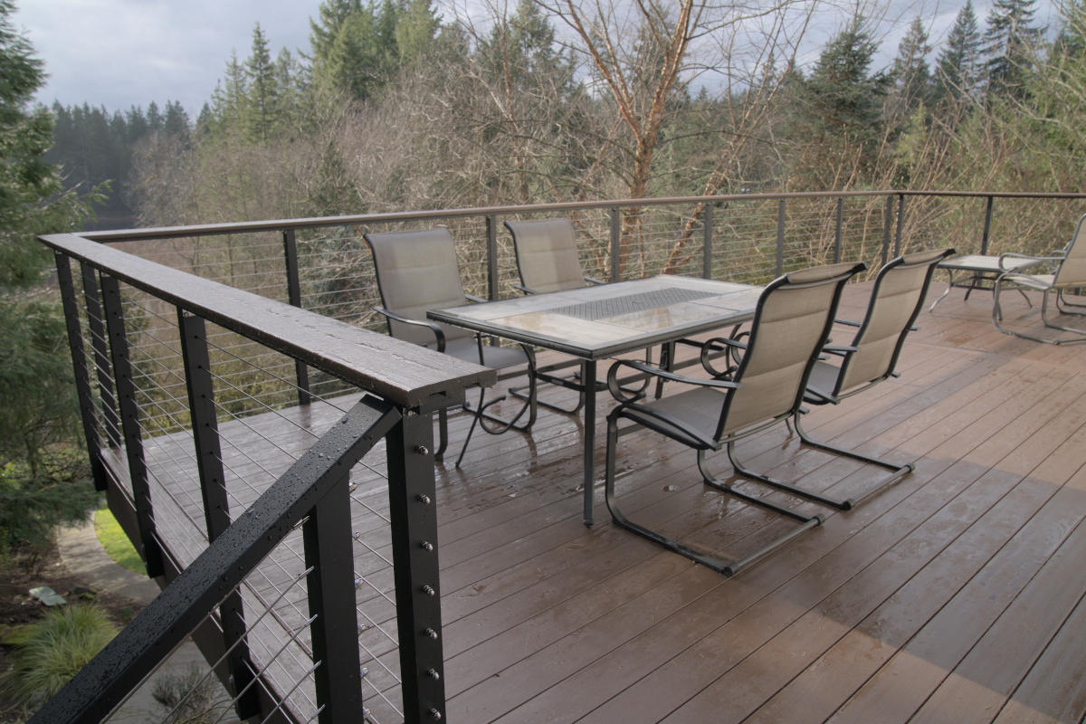 Redmond deck balcony build with outdoor furniture see through cable railing in the forest