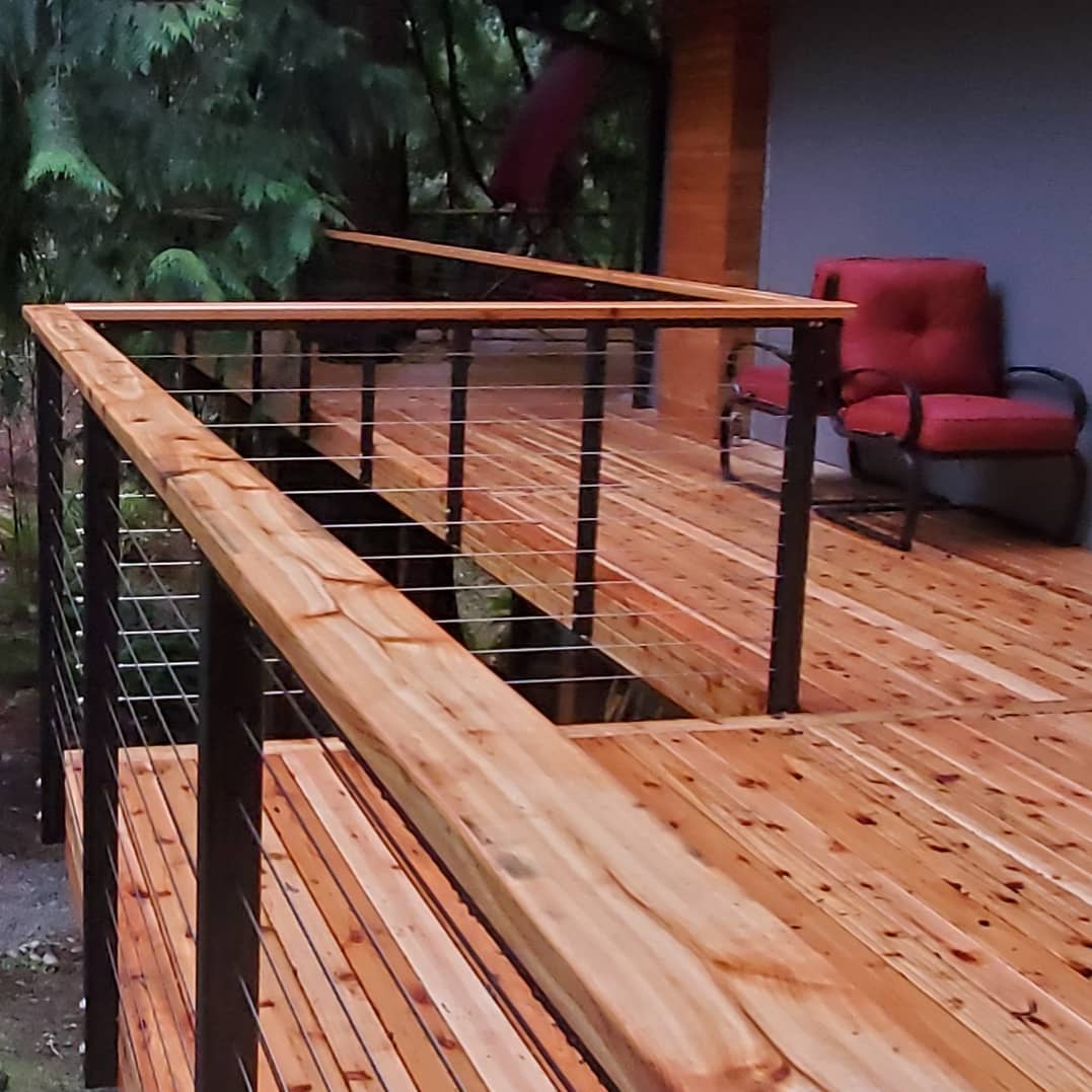 Check out this natural cedar wood deck we built with modern stainless steel cable railing in the Seattle area.