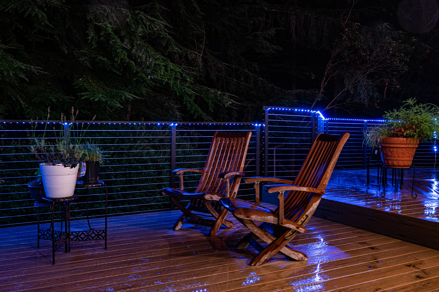 At nighttime, this wraparound railing is beautifully illuminated by embedded LED outdoor lighting.