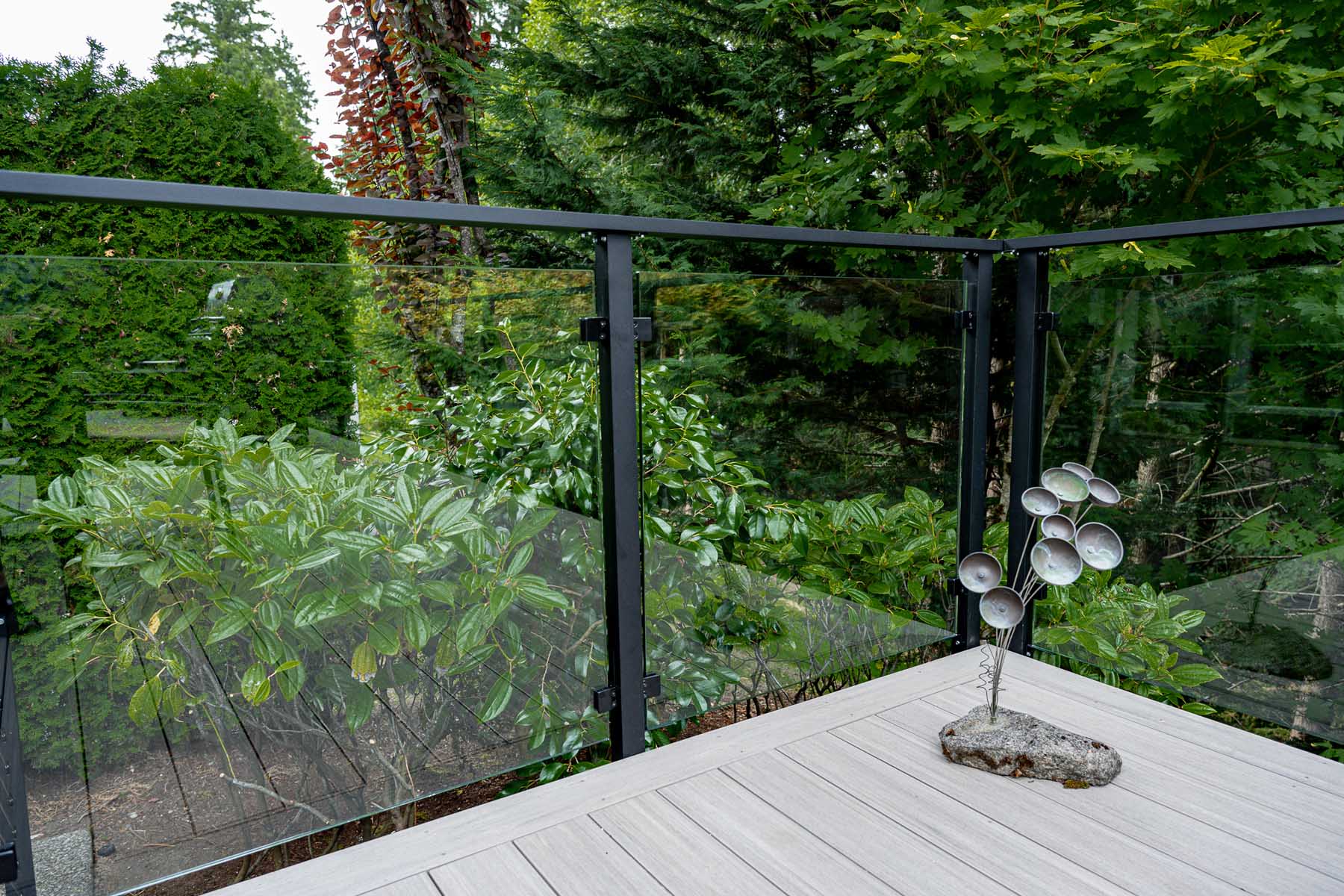 Framed glass railing with steel cable gates and stairs up to the deck