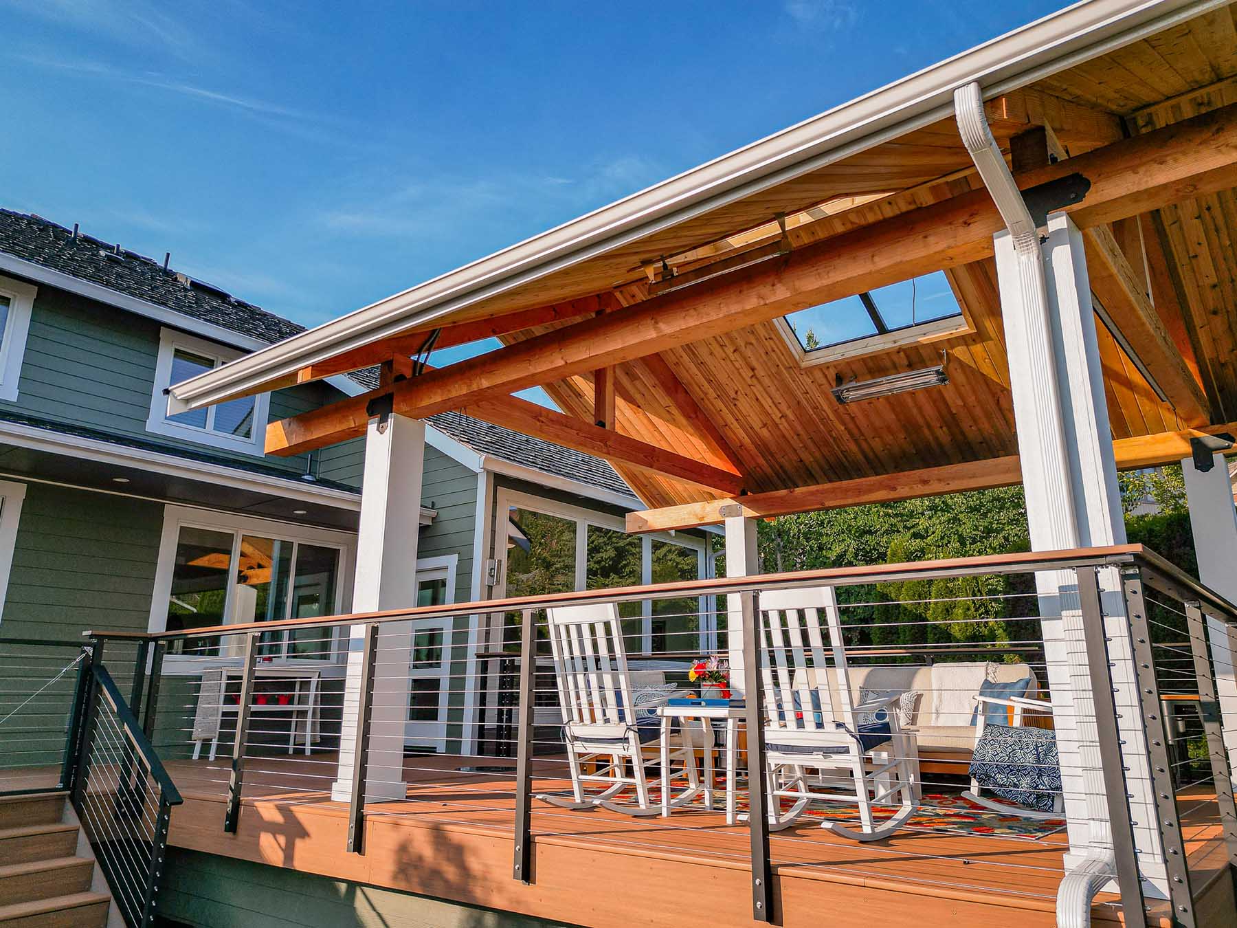 Independent roof deck cover with natural wood trim keeps you out of the rain in style